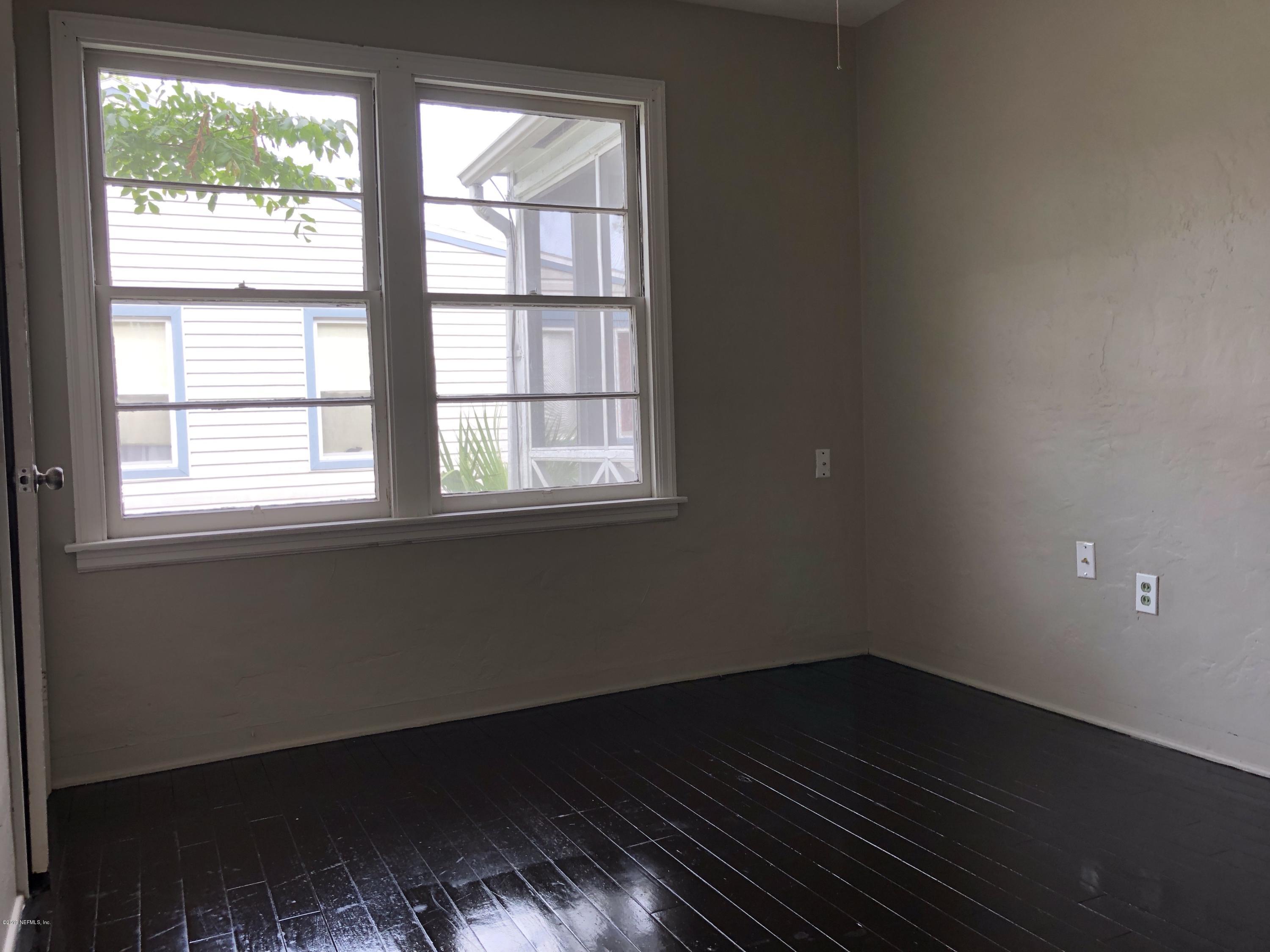 5146 Sunderland Road Jacksonville, FL 32210 - Photo 10 of 10 a view of an empty room with wooden floor and a window