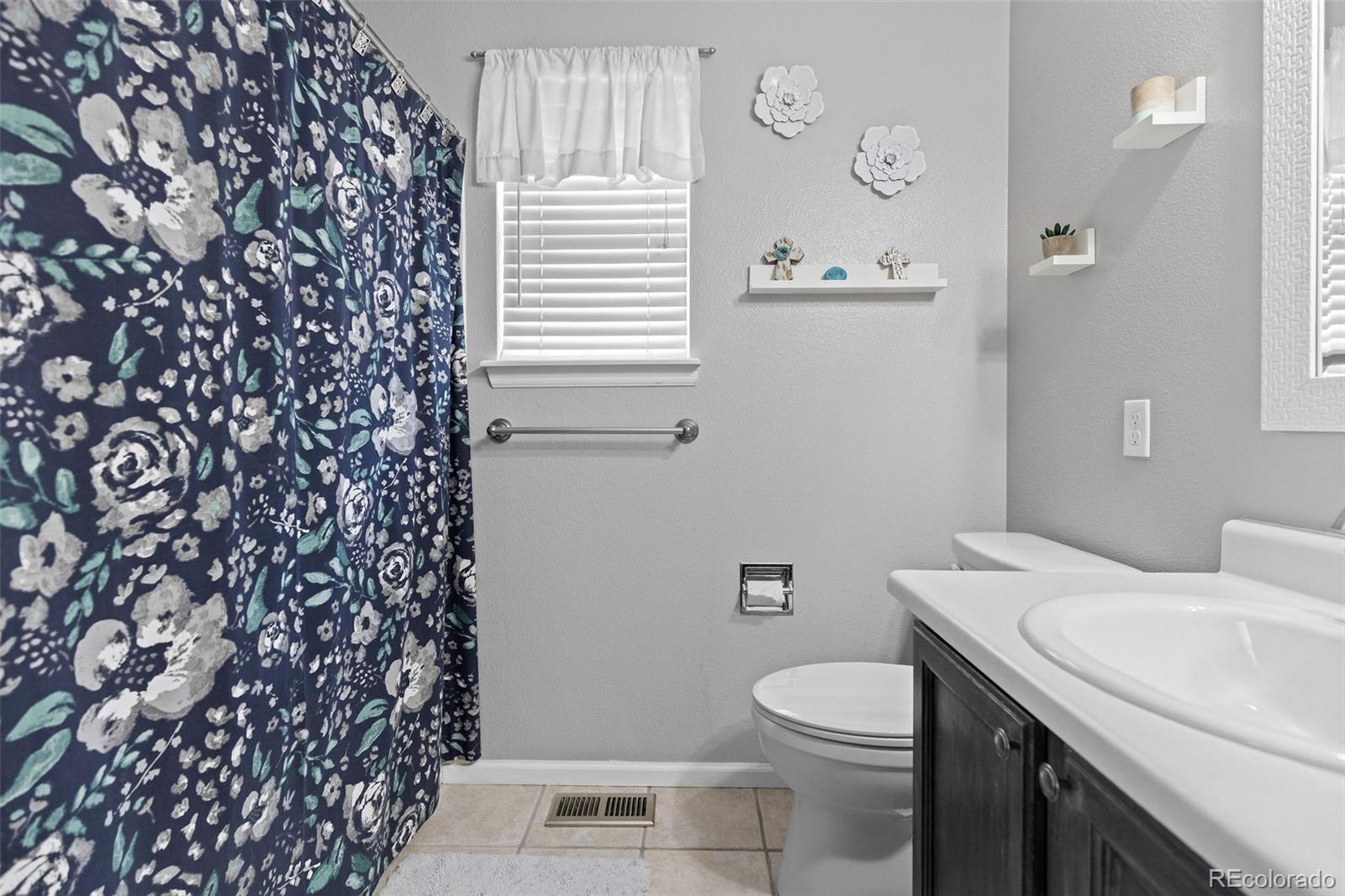 10565 Hyacinth Place Highlands Ranch, CO 80129 - Photo 21 of 33 a bathroom with a granite countertop toilet and a sink