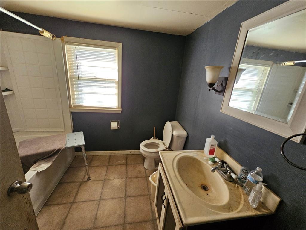 129 Brady Street Toccoa, GA 30577 - Photo 7 of 16 a bathroom with a sink a toilet and a mirror