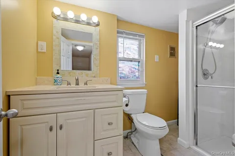 a bathroom with a sink a toilet and shower