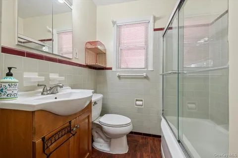 a bathroom with a sink toilet a mirror and shower