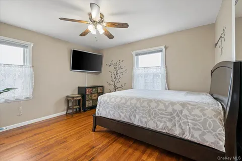 a bedroom with a bed a table and a flat screen tv