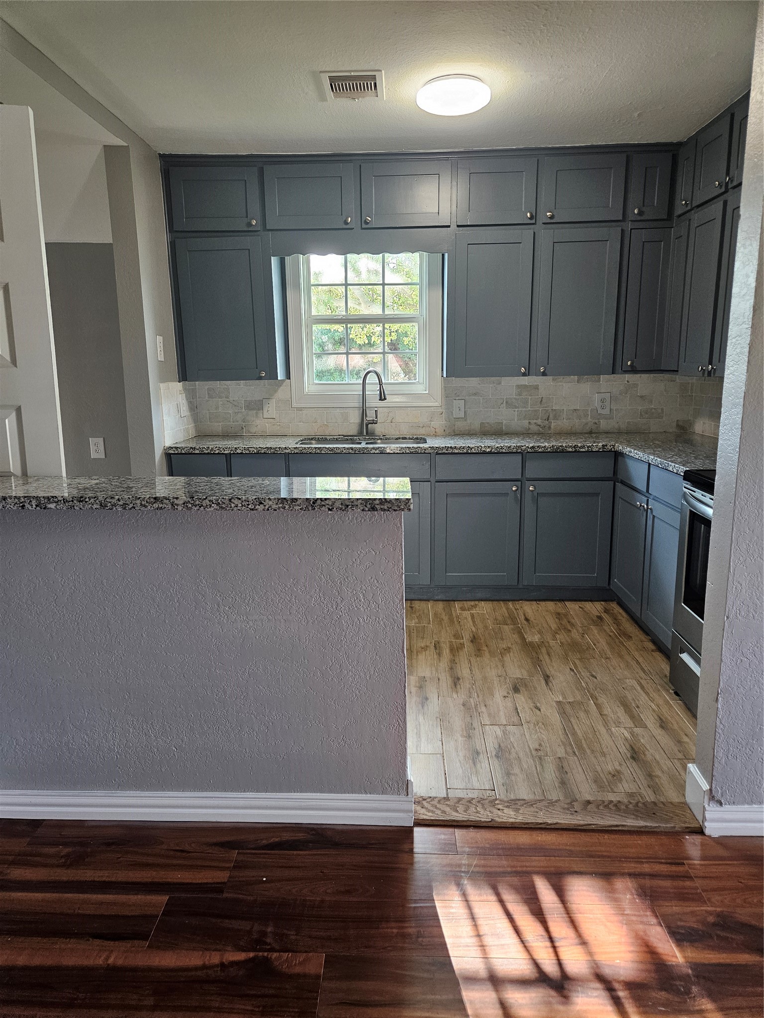 2017 3rd Street Galena Park, TX 77547 - Photo 4 of 23 a kitchen with a sink a stove cabinets and counter space