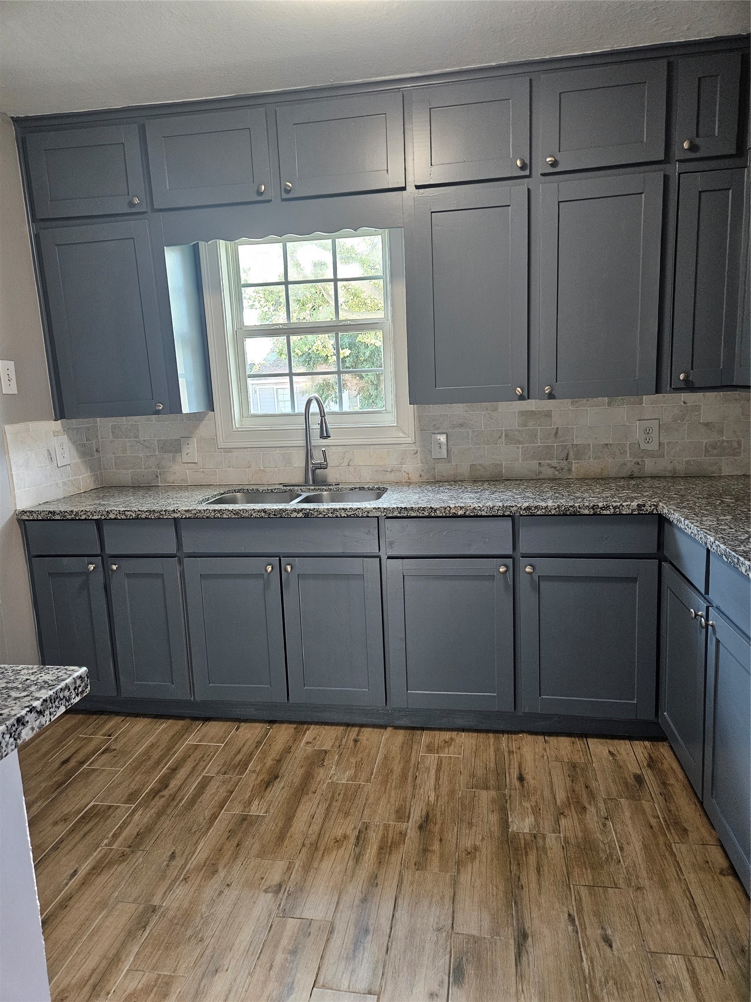 2017 3rd Street Galena Park, TX 77547 - Photo 5 of 23 a kitchen with granite countertop wooden cabinets a sink and dishwasher