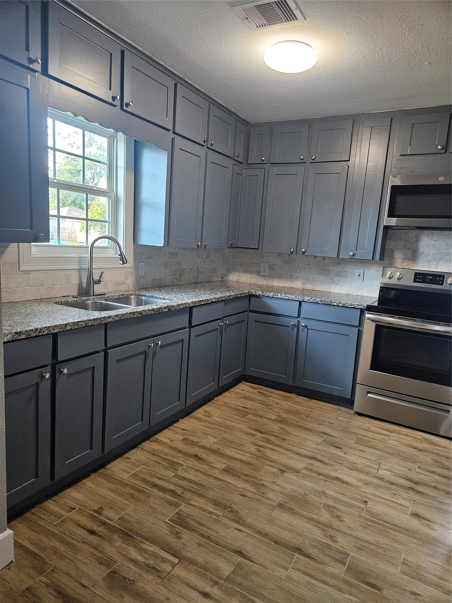 2017 3rd Street Galena Park, TX 77547 - Photo 6 of 23 a kitchen with stainless steel appliances granite countertop a sink stove and cabinets