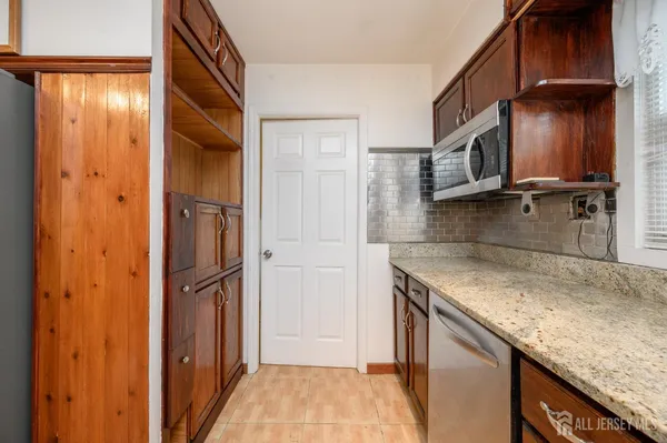 a kitchen with a refrigerator and a sink