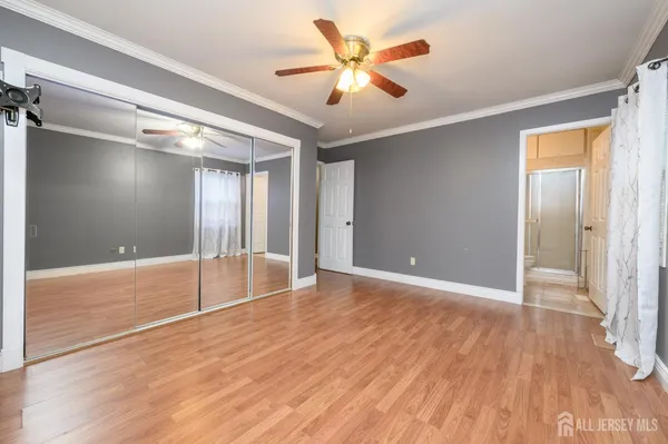 a view of an empty room and window with wooden floor
