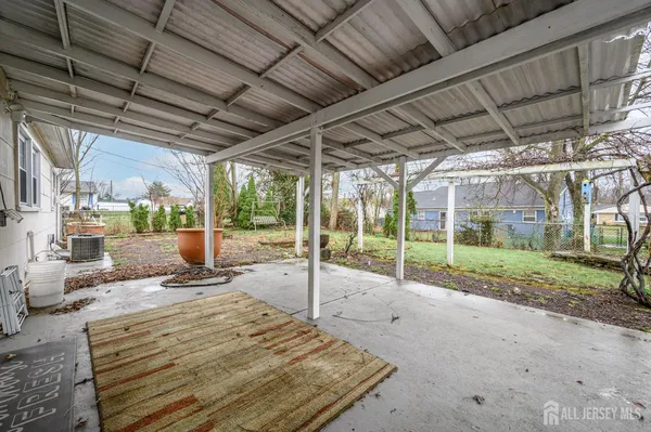a view of a backyard with porch and furniture