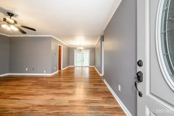 a view of empty room with wooden floor