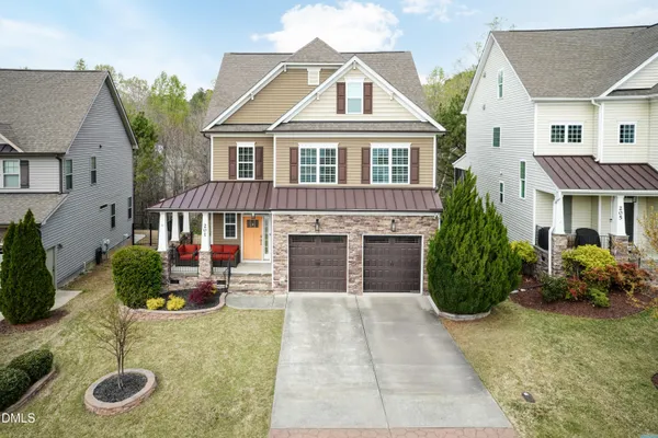 a front view of a house with garden