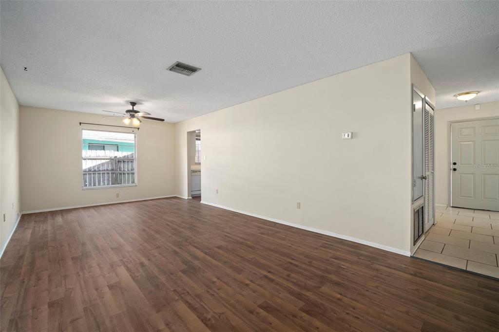 810 Black Knight Drive Valrico, FL 33594 - Photo 22 of 44 an empty room with wooden floor and windows