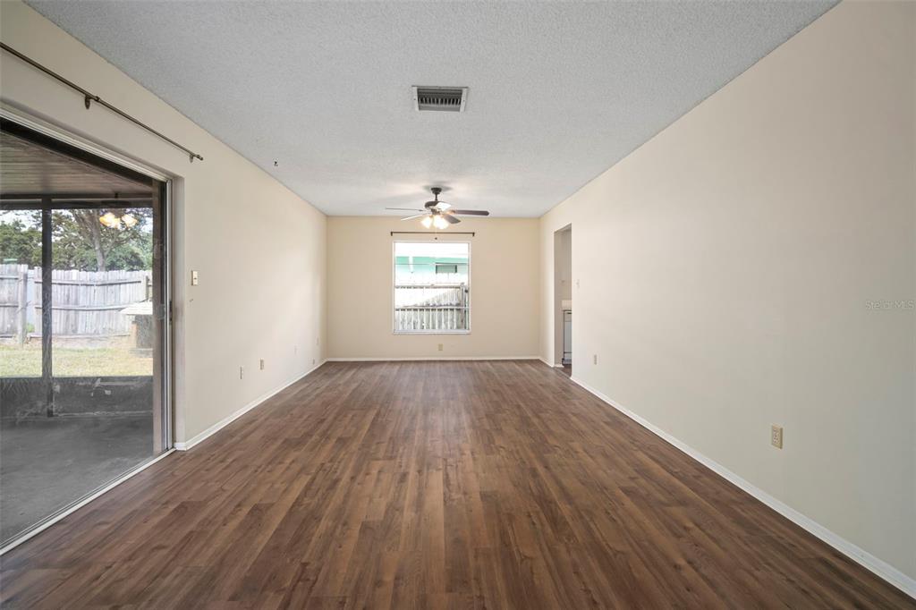 810 Black Knight Drive Valrico, FL 33594 - Photo 24 of 44 an empty room with wooden floor and windows