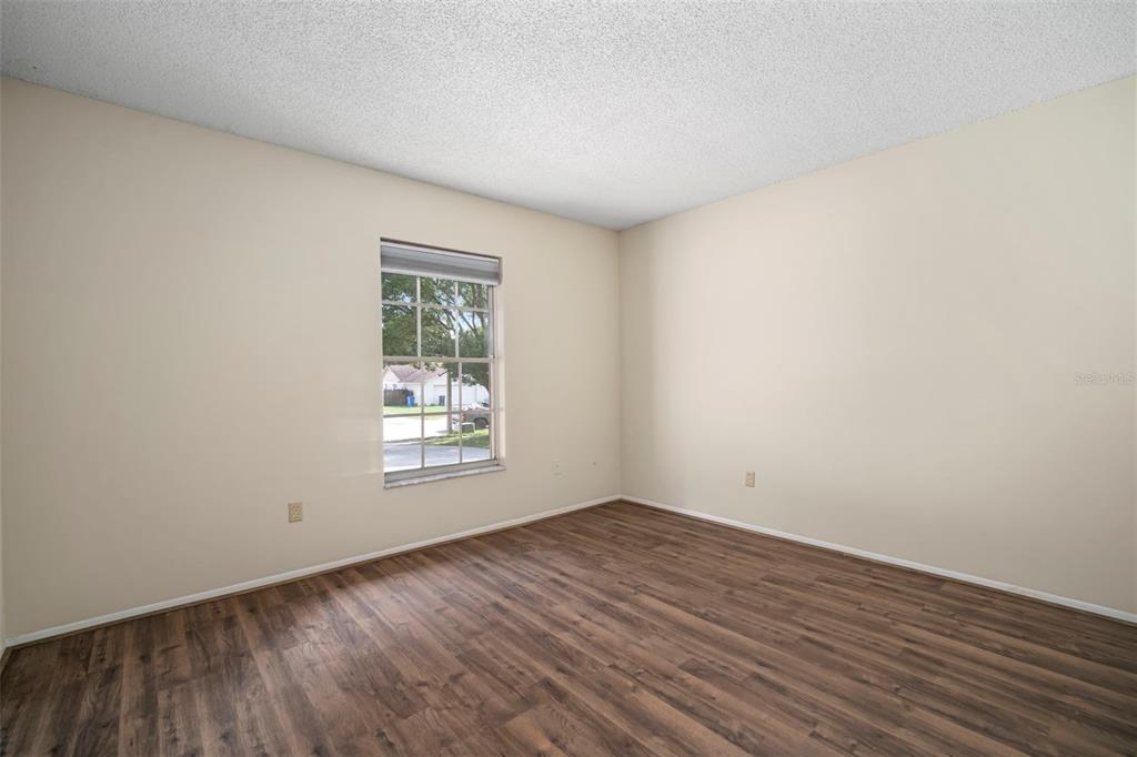 810 Black Knight Drive Valrico, FL 33594 - Photo 25 of 44 wooden floor in an empty room with a window