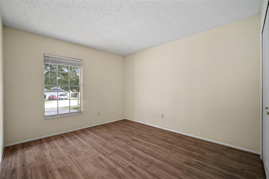 810 Black Knight Drive Valrico, FL 33594 - Photo 28 of 44 an empty room with wooden floor and windows