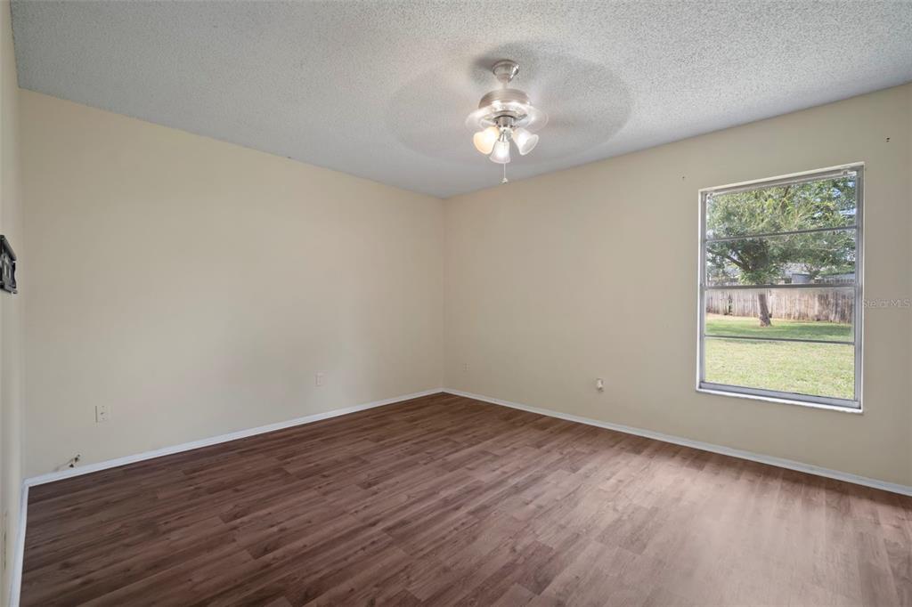 810 Black Knight Drive Valrico, FL 33594 - Photo 30 of 44 a view of an empty room with wooden floor and a window