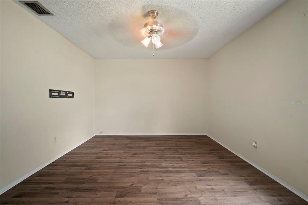 810 Black Knight Drive Valrico, FL 33594 - Photo 33 of 44 a view of a room with wooden floor and a ceiling fan