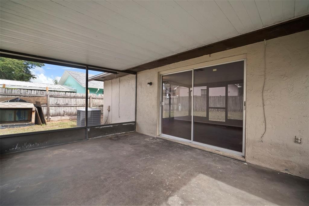810 Black Knight Drive Valrico, FL 33594 - Photo 37 of 44 an empty room with sliding door and outdoor space