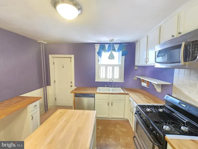 a kitchen with a stove a sink and a refrigerator