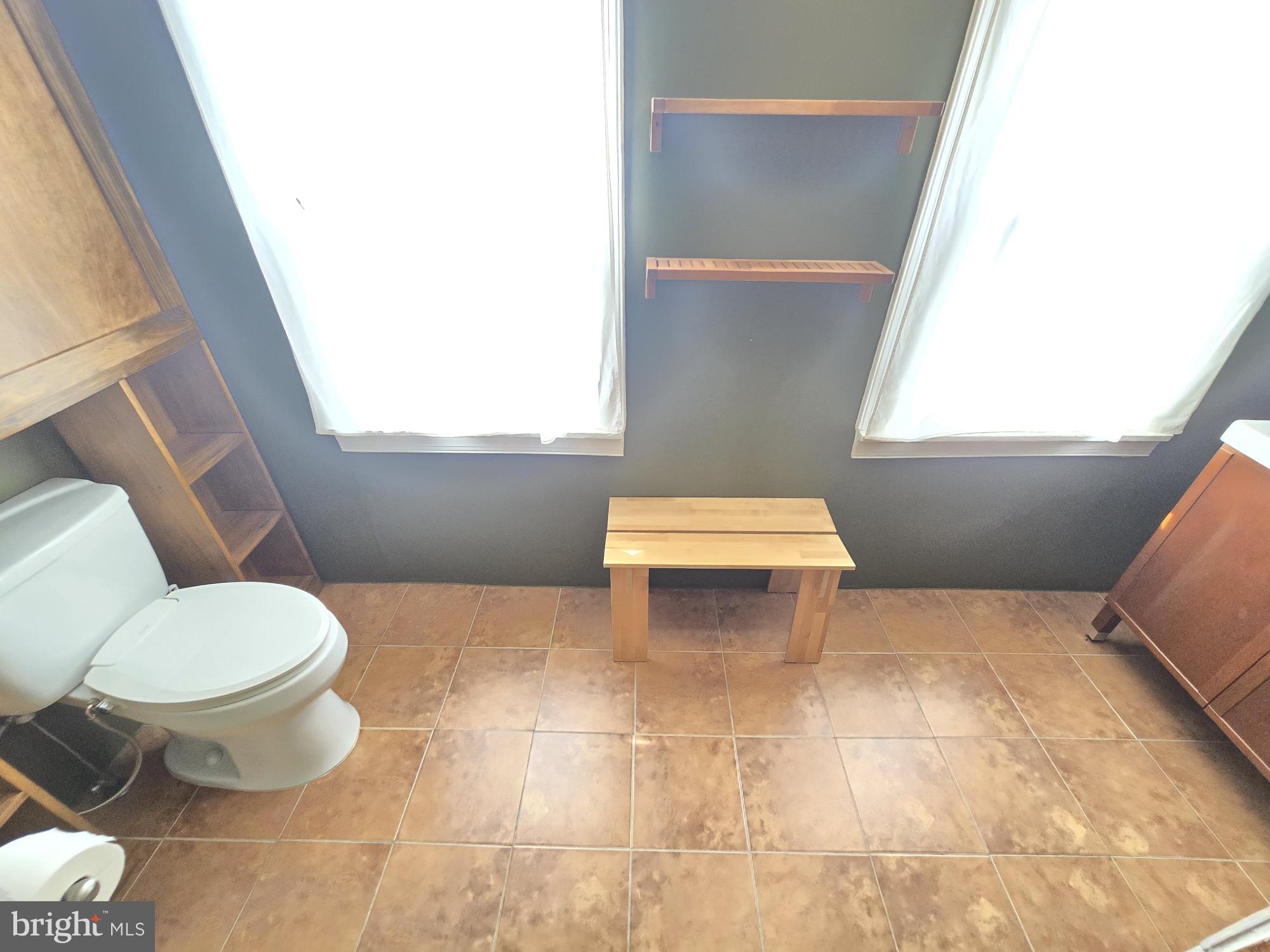 2 North Luzerne Avenue Baltimore, MD 21224 - Photo 28 of 31 a bathroom with a toilet sink and window