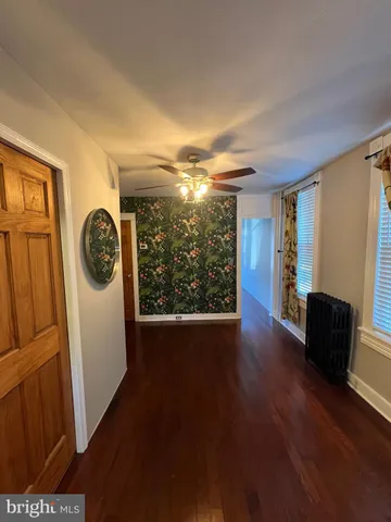 a view of an entryway with wooden floor