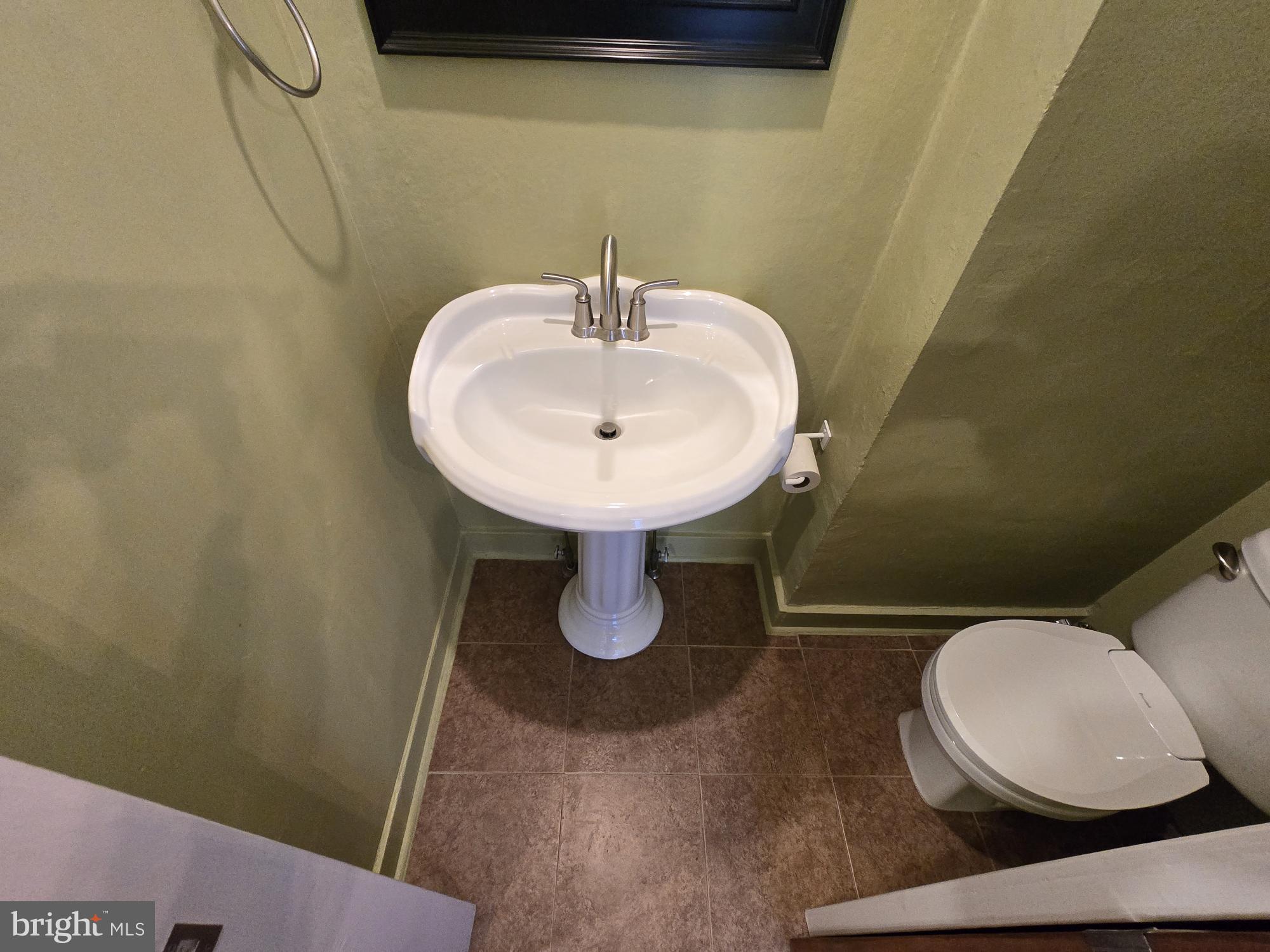 2 North Luzerne Avenue Baltimore, MD 21224 - Photo 8 of 31 a bathroom with a toilet sink and mirror