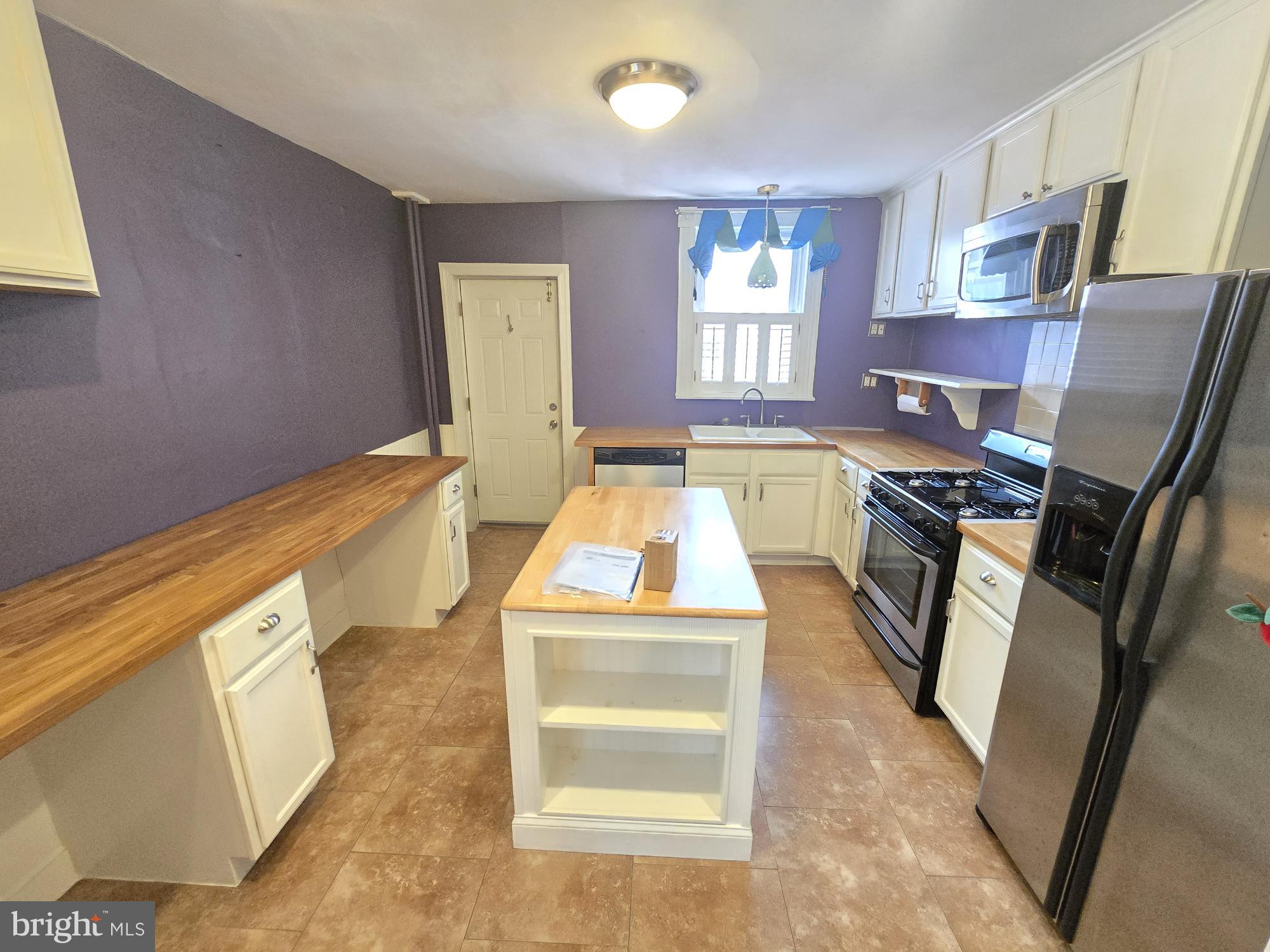 2 North Luzerne Avenue Baltimore, MD 21224 - Photo 10 of 31 a kitchen with stainless steel appliances granite countertop a stove a sink and a microwave