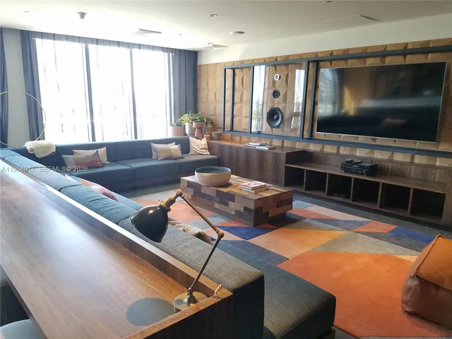 a living room with furniture window and flat screen tv
