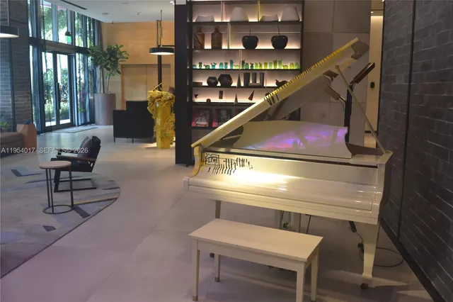 a living room with furniture and a floor to ceiling window