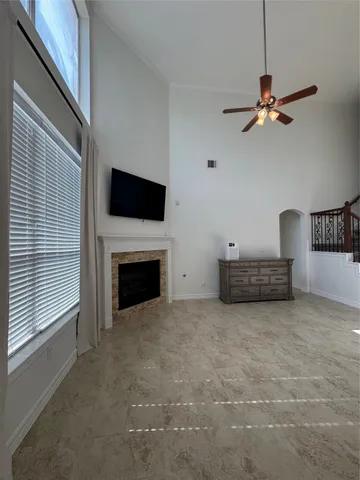 a view of a livingroom with an empty space and a fireplace