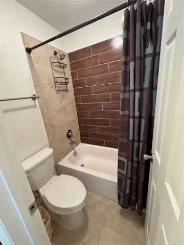a bathroom with a toilet and a tub
