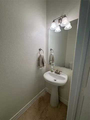 a bathroom with a sink a mirror and a toilet