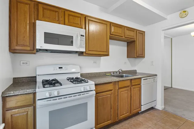 a kitchen with stainless steel appliances granite countertop a stove and a microwave