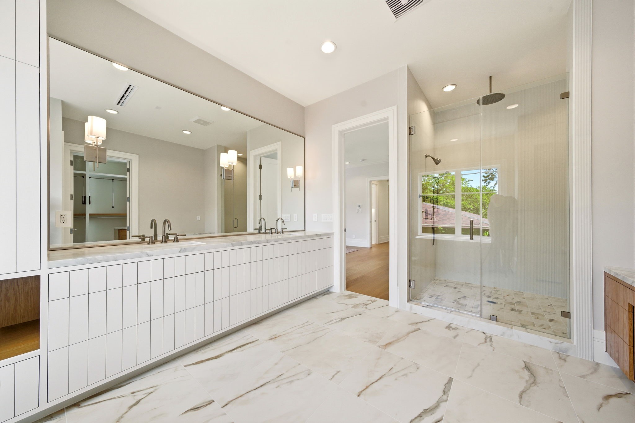 1023 Euclid Street Houston, TX 77009 - Photo 6 of 50 Gorgeous primary bath with oversized dual vanity, frameless glass shower, and elegant spa-like finishes.
