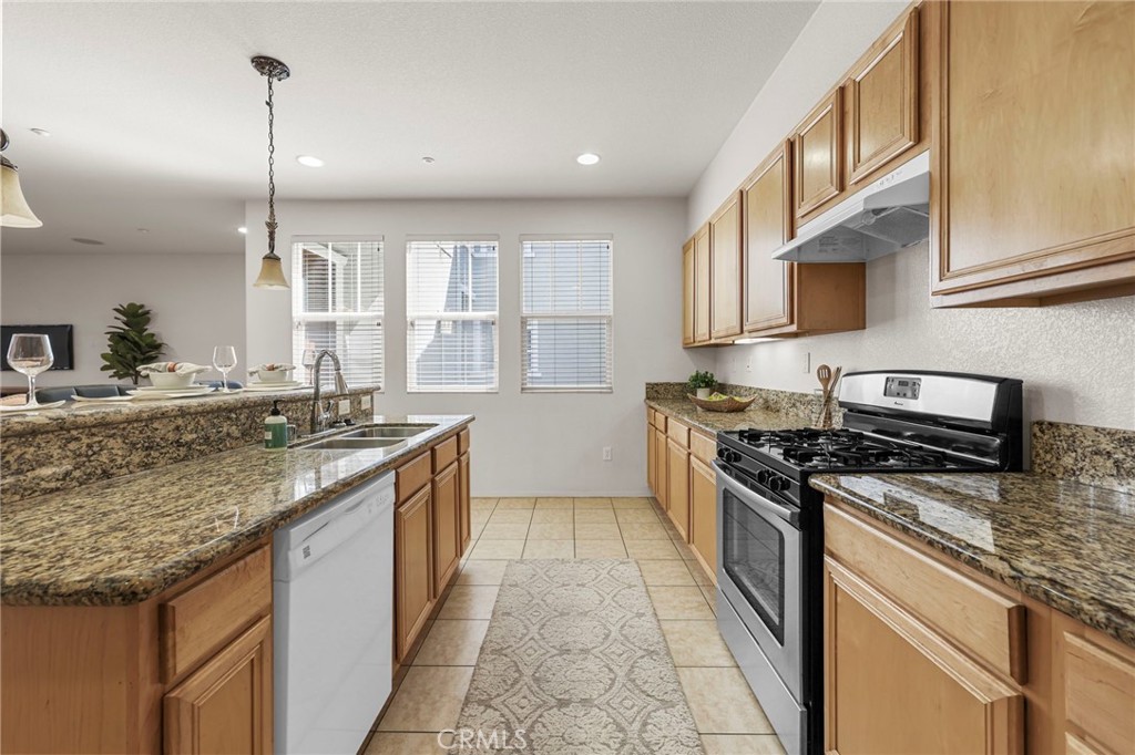 10375 Church, Unit 124 Rancho Cucamonga, CA 91730 - Photo 14 of 34 a kitchen with stainless steel appliances granite countertop a stove and a sink