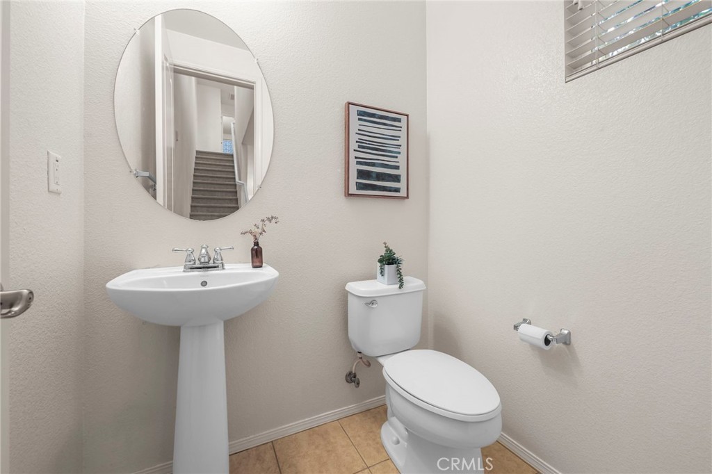 10375 Church, Unit 124 Rancho Cucamonga, CA 91730 - Photo 15 of 34 a bathroom with a toilet sink and mirror