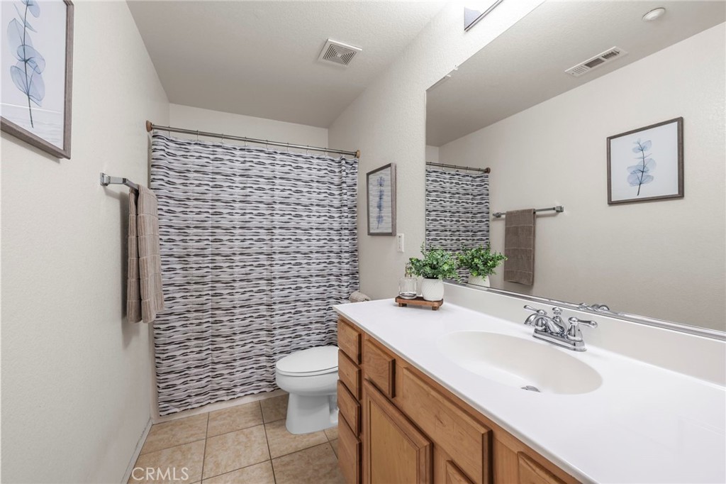 10375 Church, Unit 124 Rancho Cucamonga, CA 91730 - Photo 16 of 34 a bathroom with a sink a toilet and shower