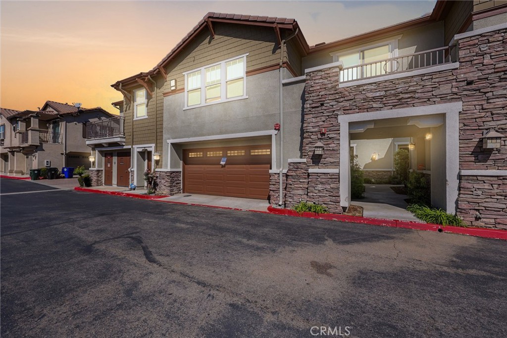 10375 Church, Unit 124 Rancho Cucamonga, CA 91730 - Photo 2 of 34 a front view of a house with a yard