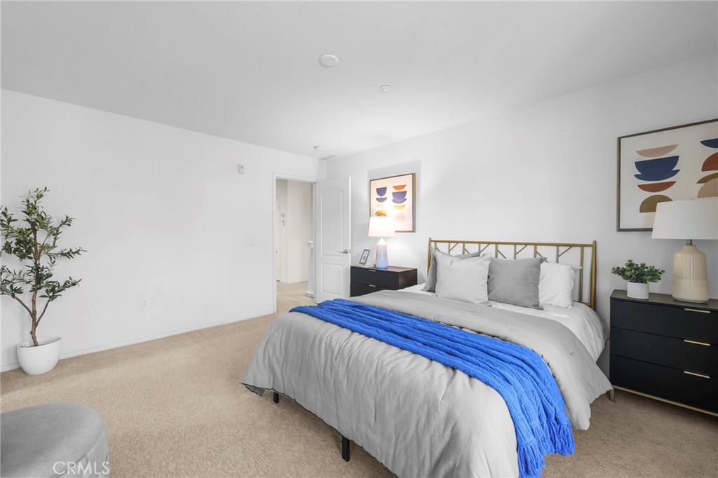 10375 Church, Unit 124 Rancho Cucamonga, CA 91730 - Photo 21 of 34 a bedroom with a bed and a potted plant