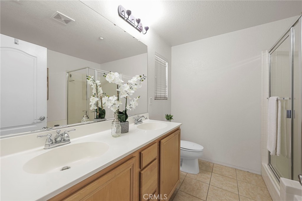 10375 Church, Unit 124 Rancho Cucamonga, CA 91730 - Photo 22 of 34 a bathroom with a sink a toilet and shower