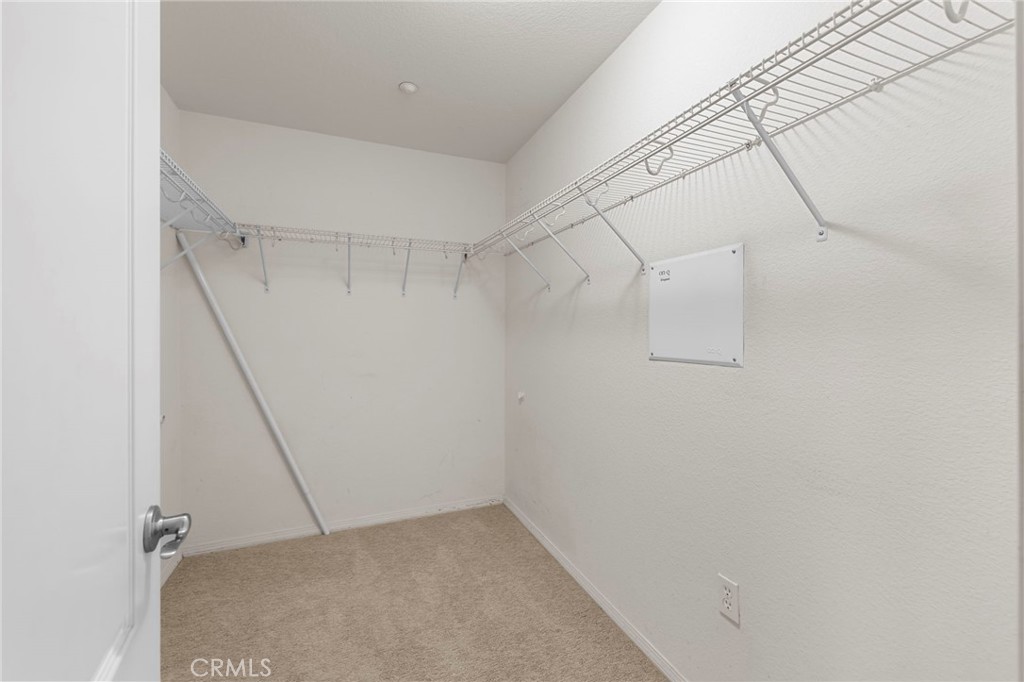 10375 Church, Unit 124 Rancho Cucamonga, CA 91730 - Photo 23 of 34 a view of a room with racks on the wall