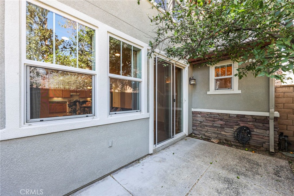 10375 Church, Unit 124 Rancho Cucamonga, CA 91730 - Photo 26 of 34 a front view of a house with a yard