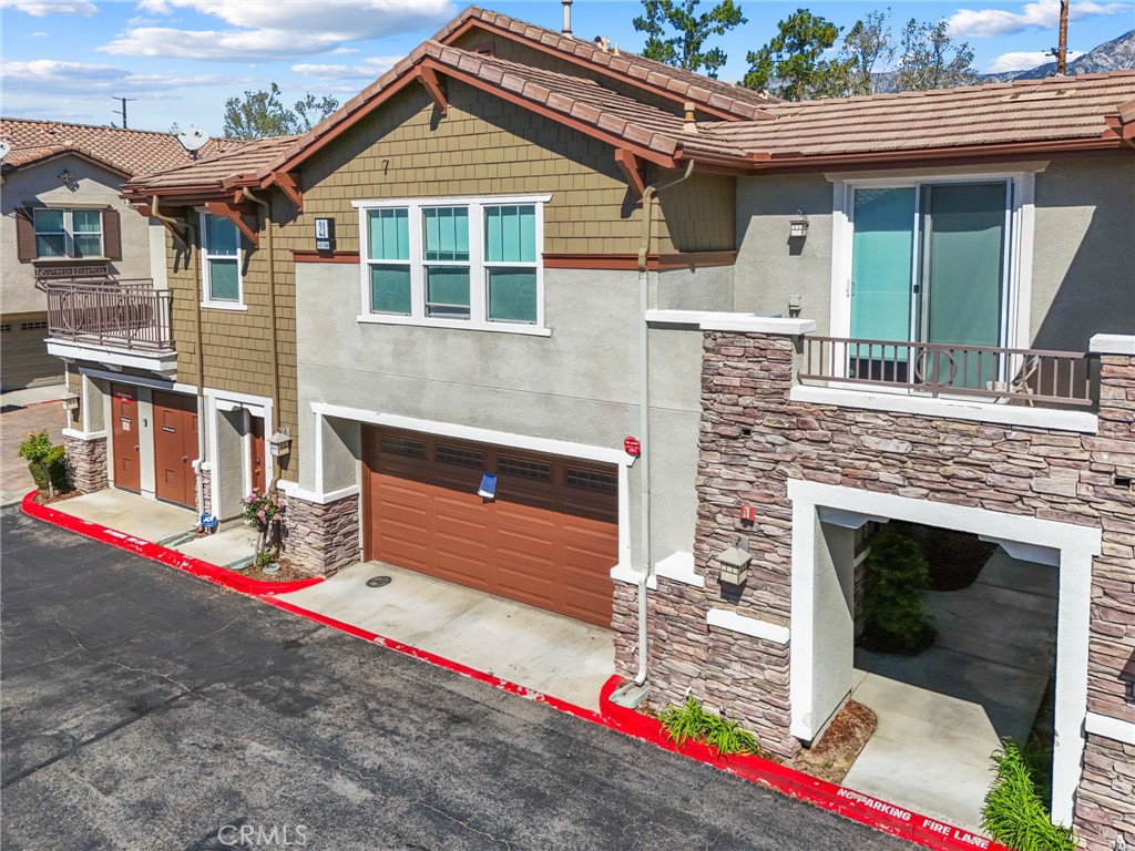 10375 Church, Unit 124 Rancho Cucamonga, CA 91730 - Photo 5 of 34 a front view of a house with a garage
