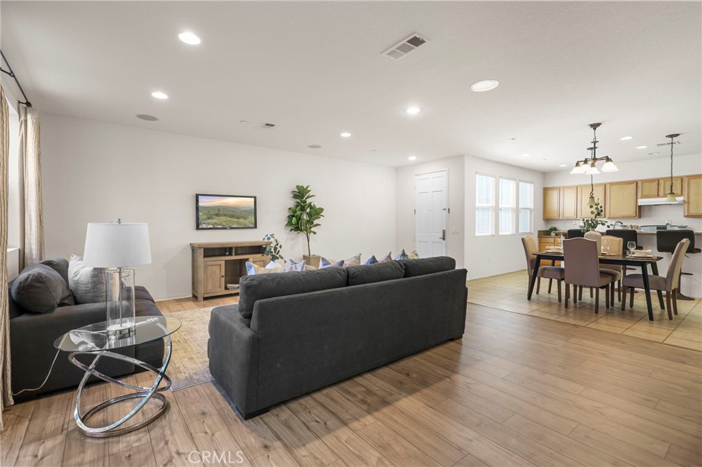 10375 Church, Unit 124 Rancho Cucamonga, CA 91730 - Photo 8 of 34 a living room with furniture and a wooden floor