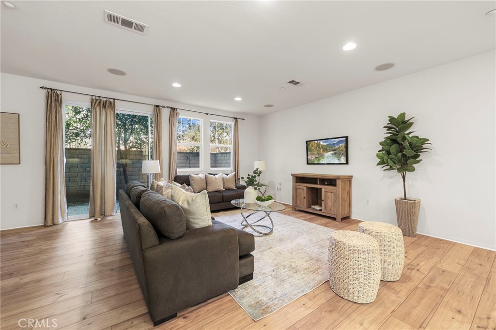 10375 Church, Unit 124 Rancho Cucamonga, CA 91730 - Photo 9 of 34 a living room with furniture and a fireplace
