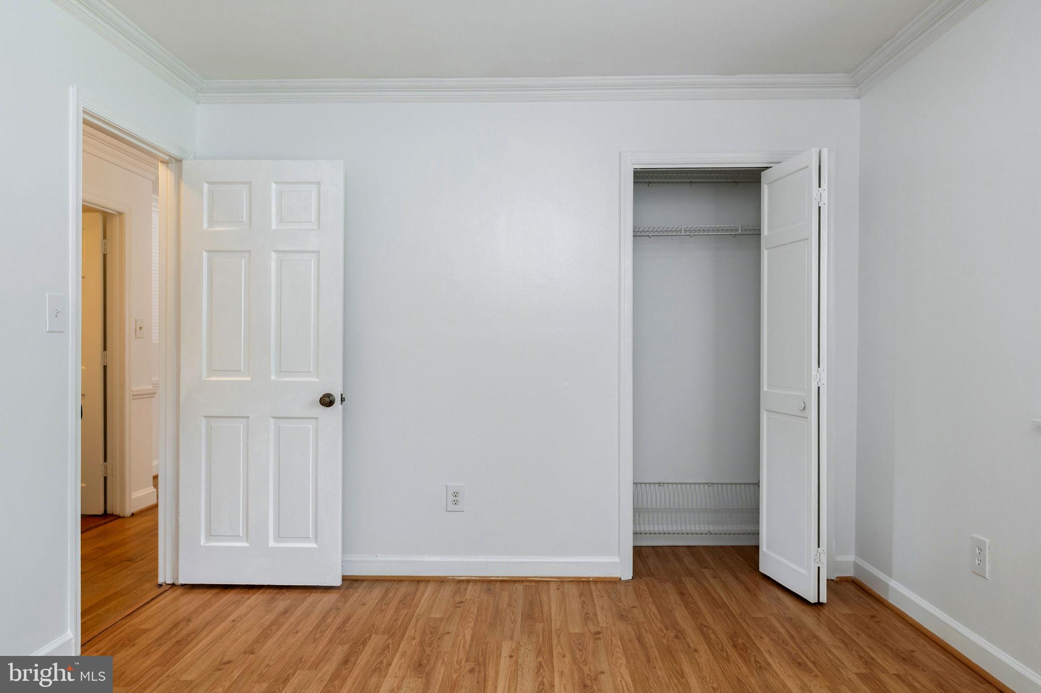 11325 Bacon Race Road Woodbridge, VA 22192 - Photo 19 of 54 an empty room with wooden floor and closet area
