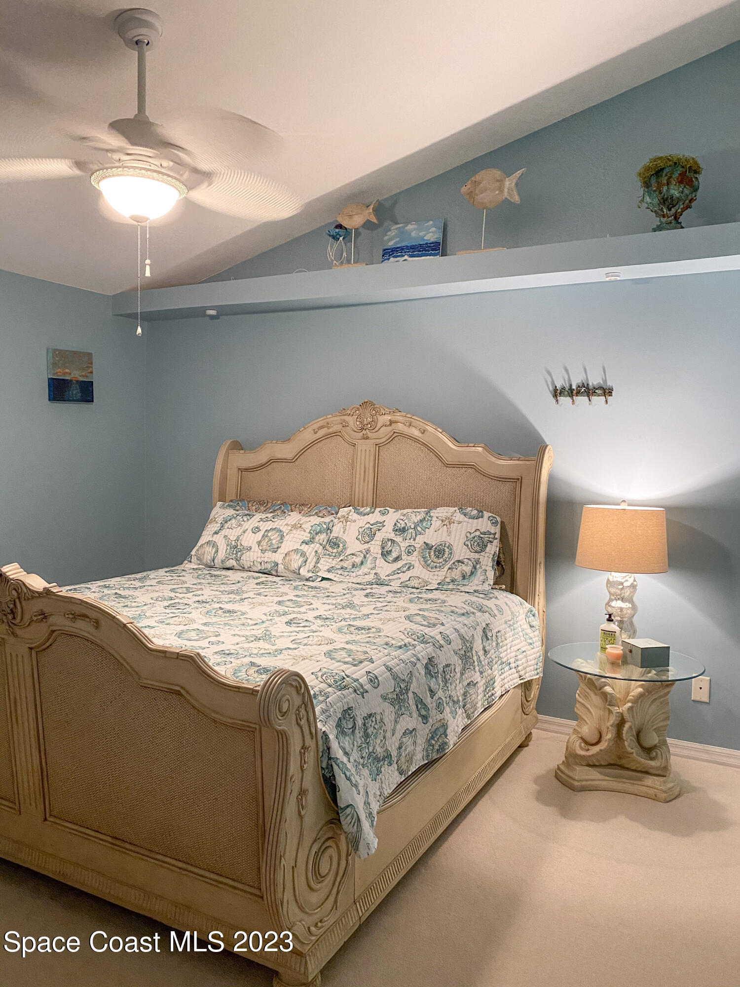 5080 Seiler Street Melbourne Beach, FL 32951 - Photo 18 of 34 a bed sitting in a bedroom next to a lamp