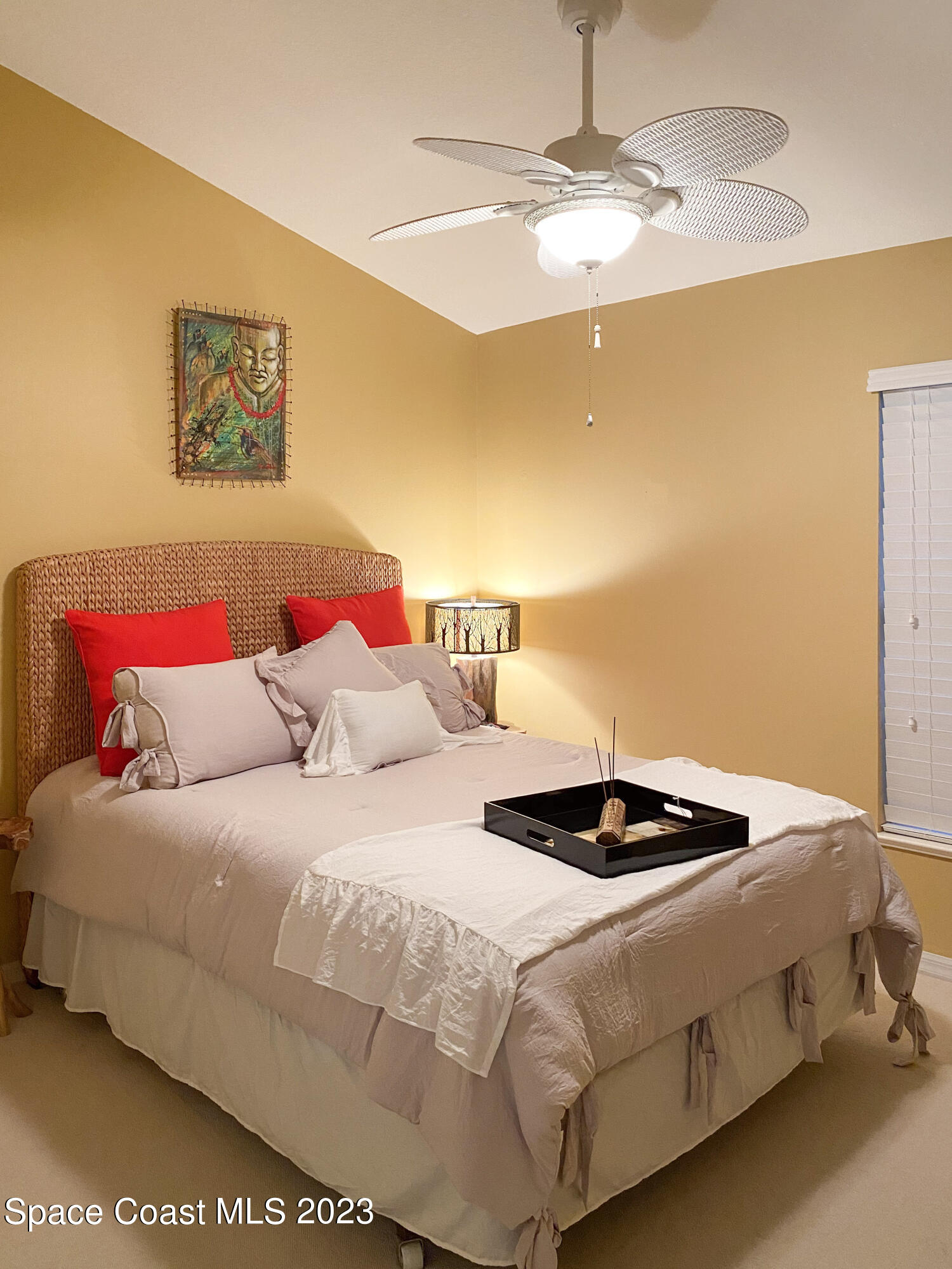 5080 Seiler Street Melbourne Beach, FL 32951 - Photo 21 of 34 a bedroom with a bed and a chandelier