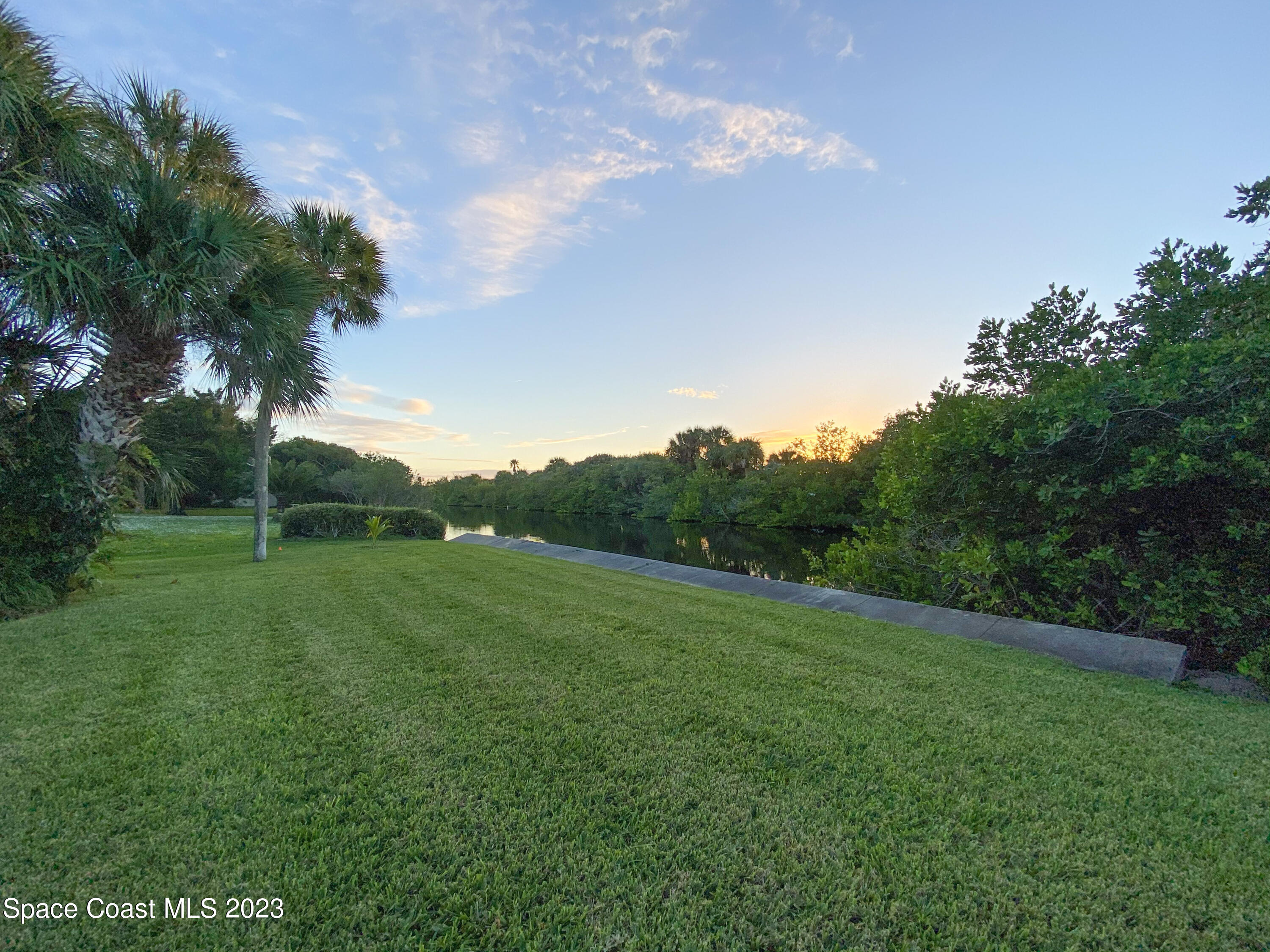 5080 Seiler Street Melbourne Beach, FL 32951 - Photo 22 of 34 a view of a grassy field with trees