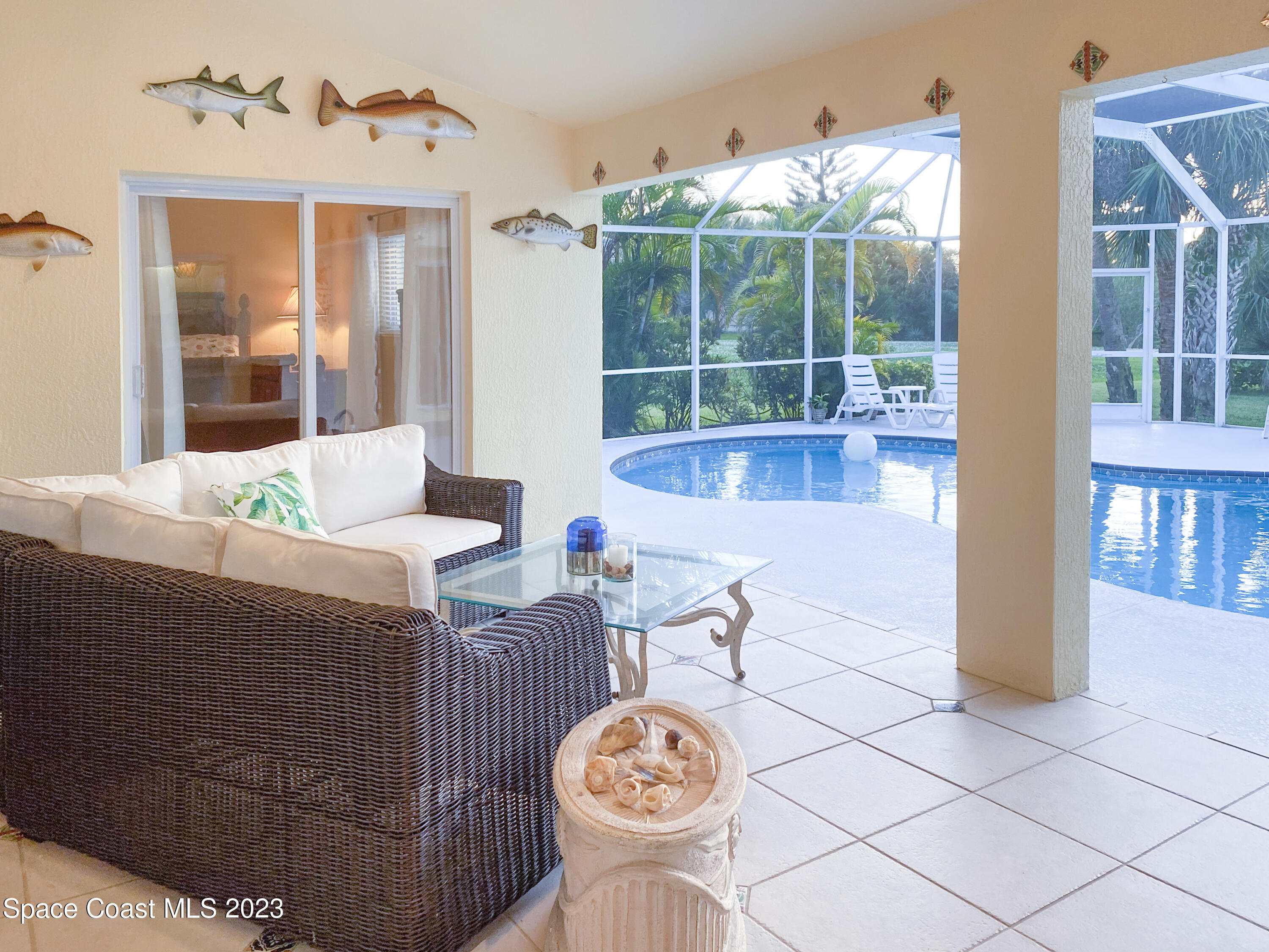 5080 Seiler Street Melbourne Beach, FL 32951 - Photo 23 of 34 a living room with furniture a table and a large window