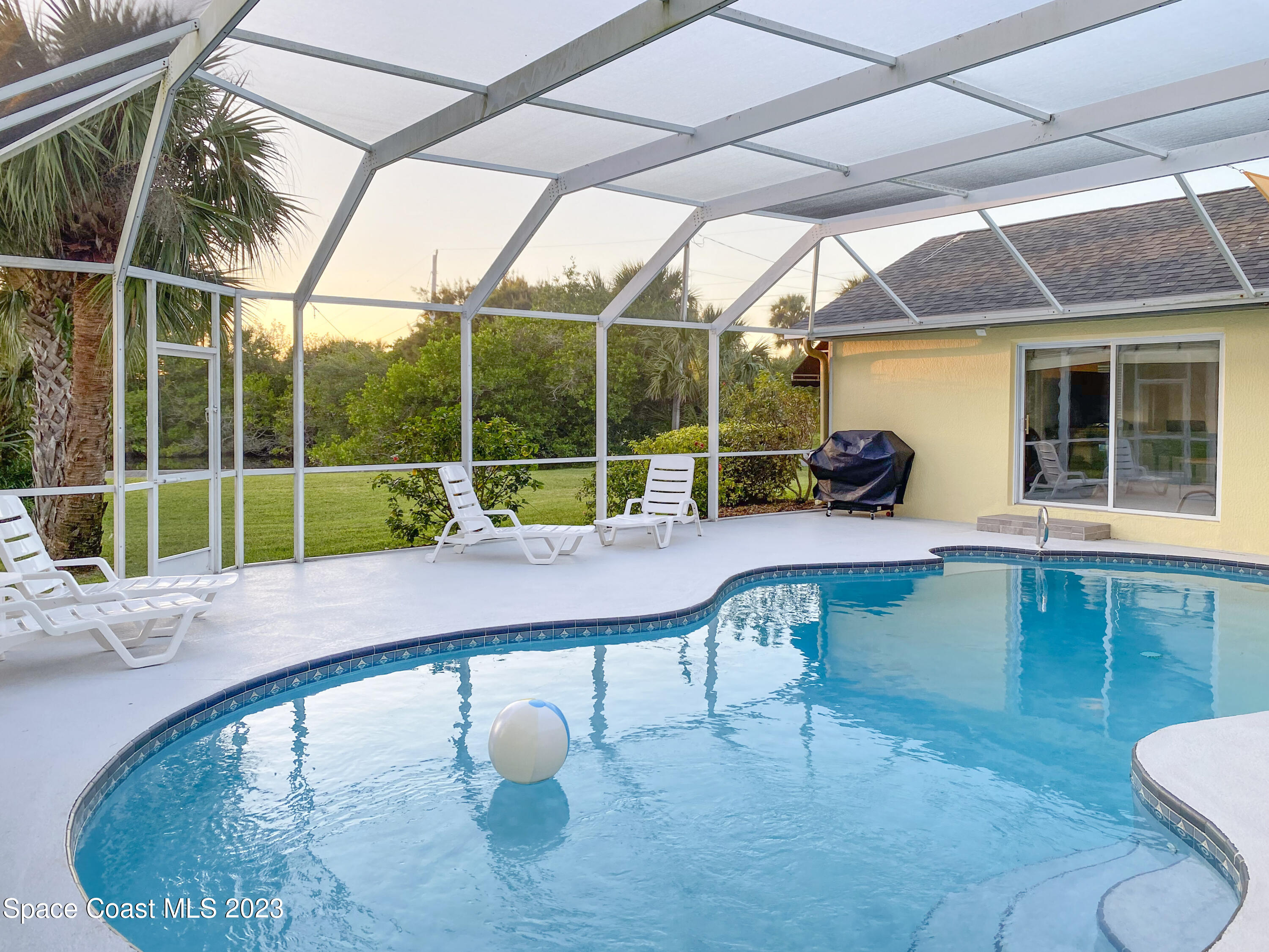 5080 Seiler Street Melbourne Beach, FL 32951 - Photo 25 of 34 a view of a swimming pool with a patio and a yard